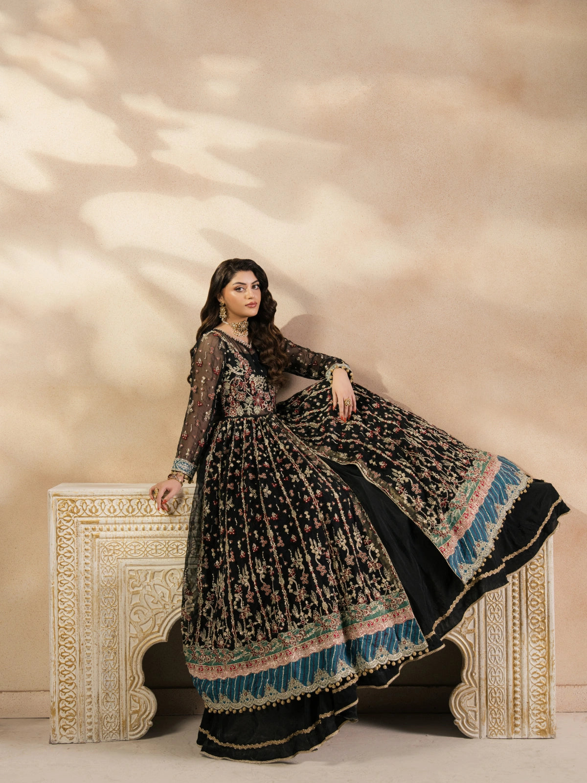 Black embroidered bridal lehenga with gold detailing and multicolor dupatta