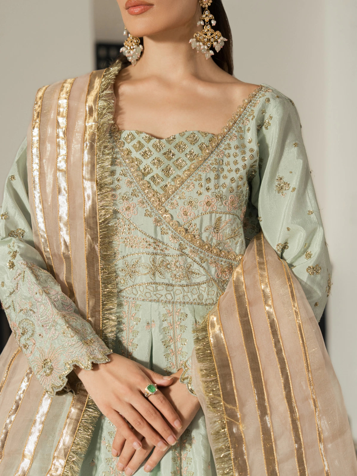 Champagne gold dupatta with metallic striped detailing styled with a mint green gown.