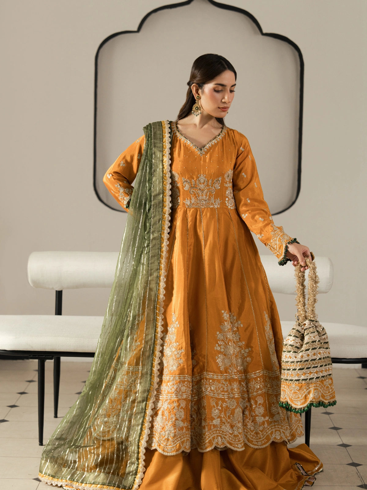 Women's mustard orange formal dress featuring intricate silver embroidery.