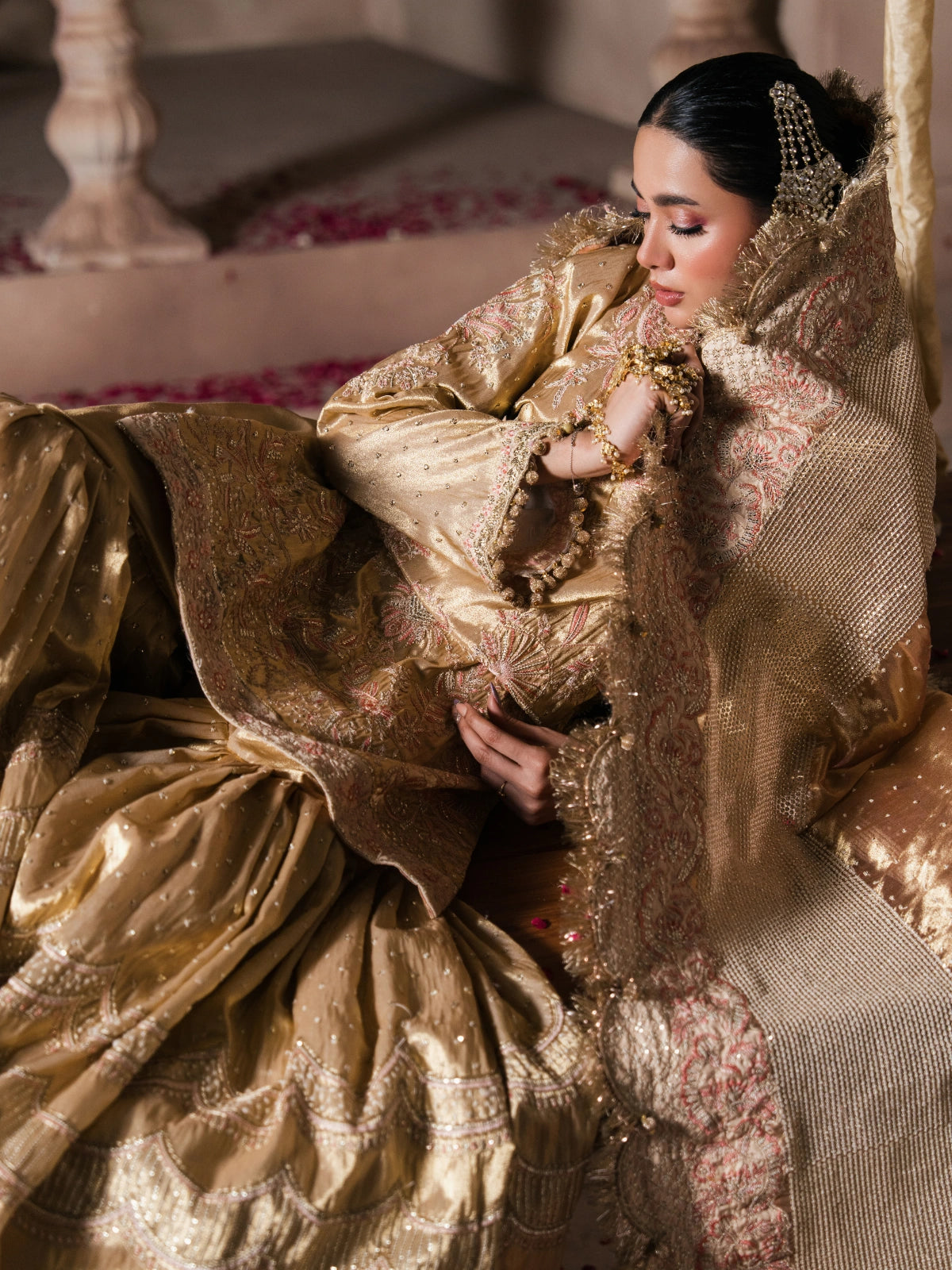 Luxury bridal sharara styled with a flowing pink and gold dupatta