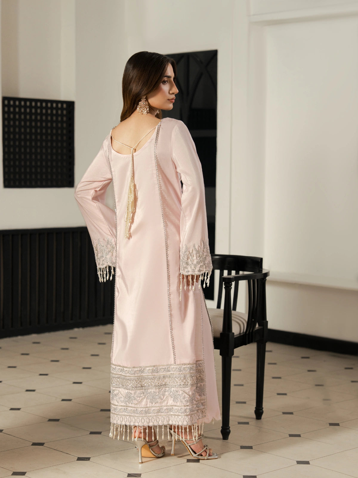 Luxury pink Pakistani dress with intricate silver embroidery on the hem.