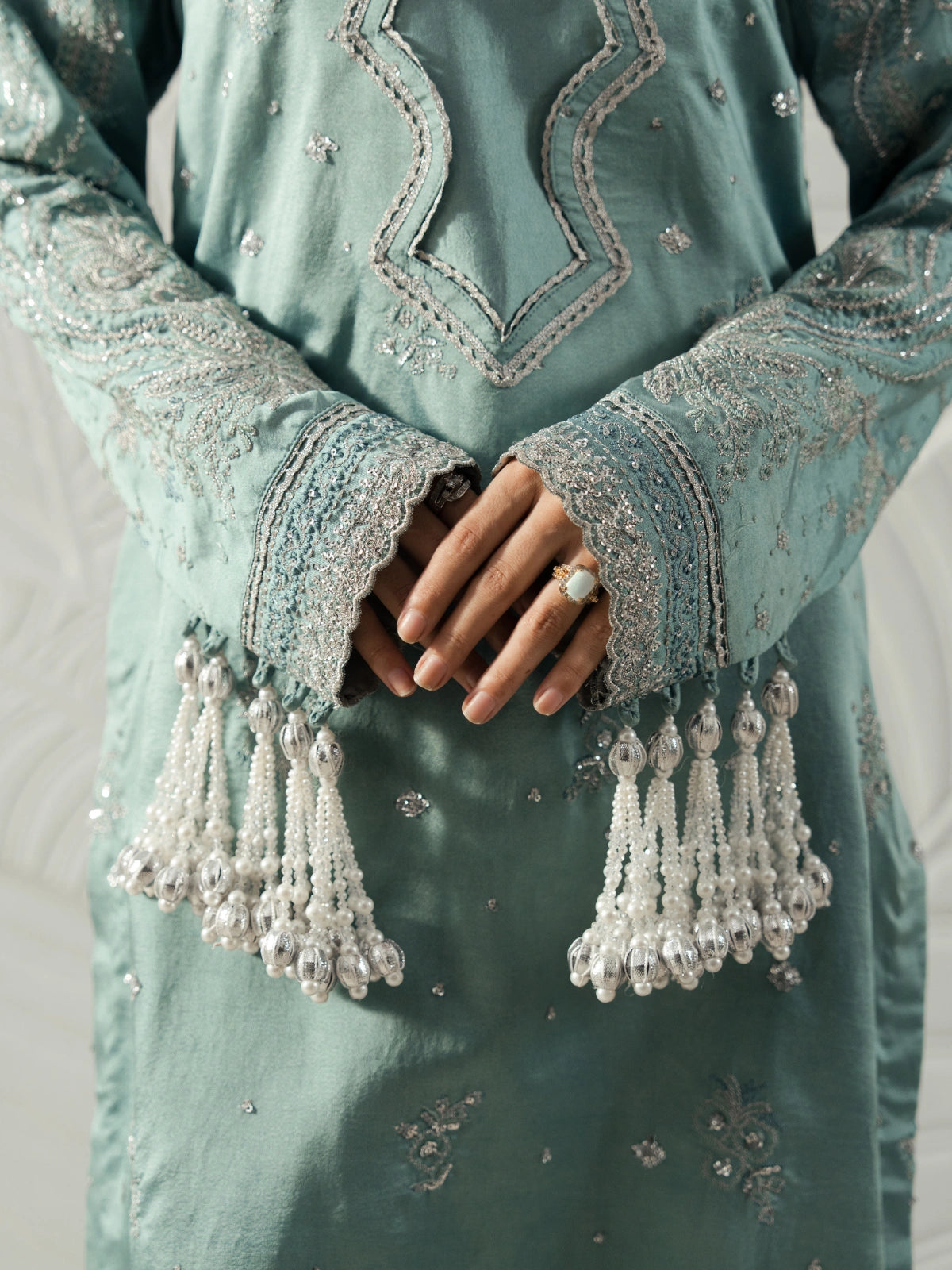 Luxury pret suit in muted green featuring a square neckline and delicate embellished detailing.