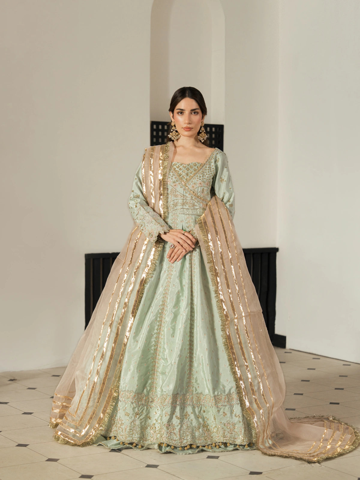 Mint green embroidered maxi dress paired with a champagne gold dupatta.