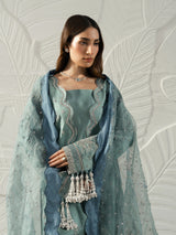 Model wearing a sage green embroidered kameez with a matching dupatta and blue border.