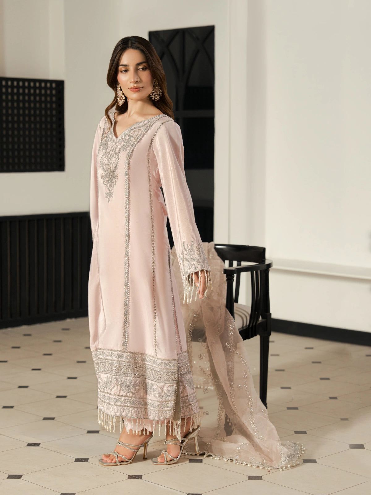 Women's blush pink formal outfit with an embellished neckline and sleeves.