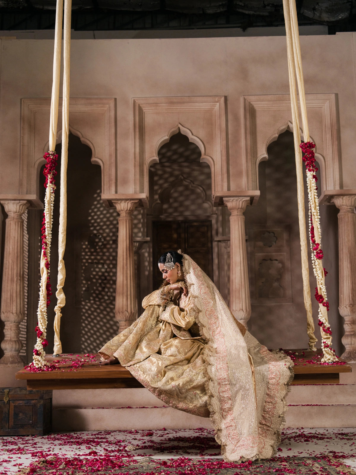 Traditional Pakistani formal wear with champagne gold fabric and detailed embroidery