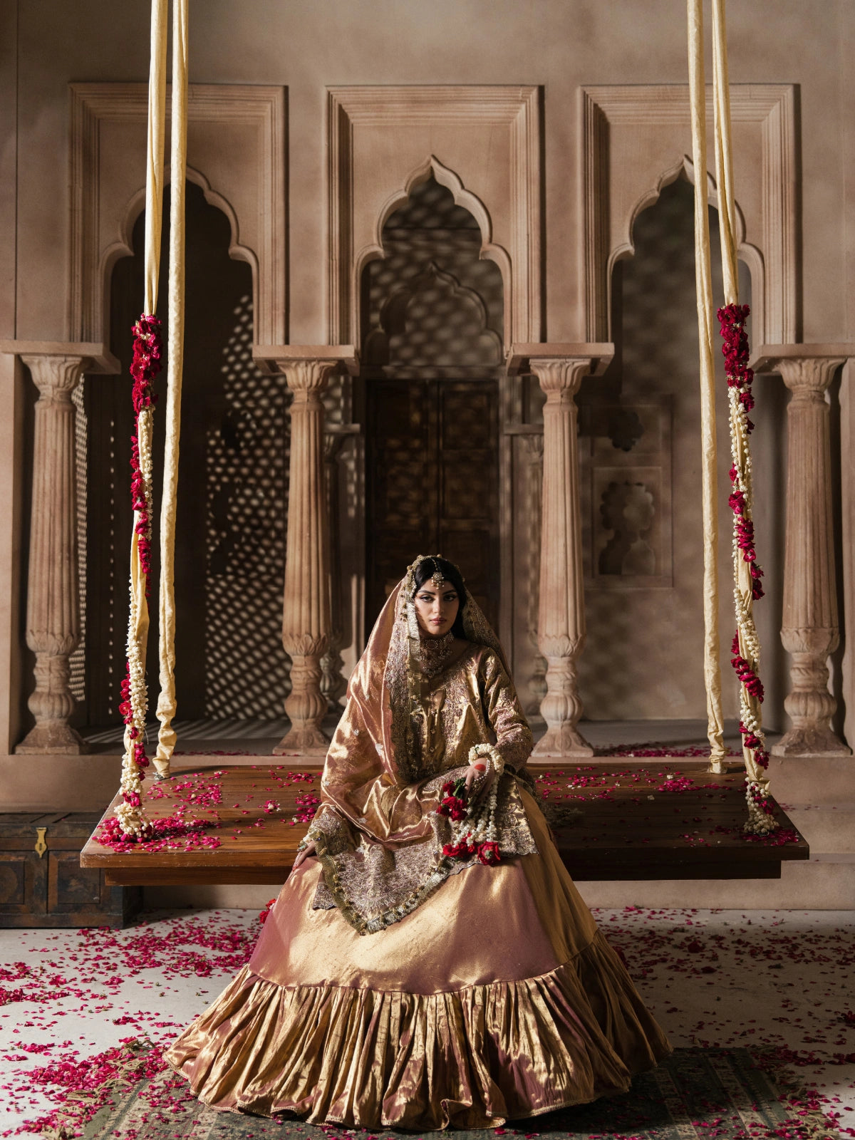 Luxury gold formal gharara with detailed embroidery and a flowing silhouette