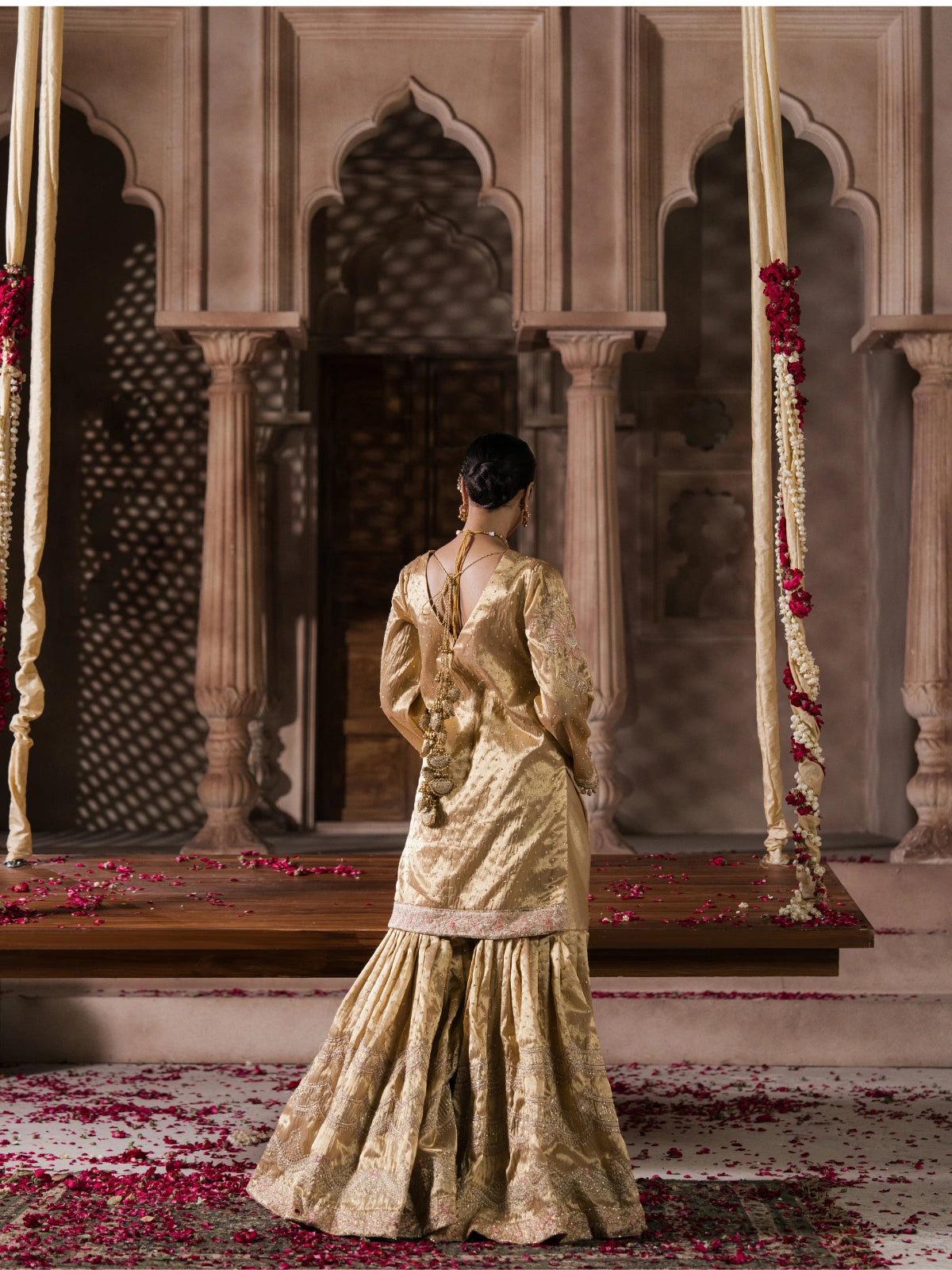 Elegant gold wedding dress with an intricately embellished long dupatta
