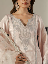 Full-length pastel pink formal suit styled with silver high-heel sandals.