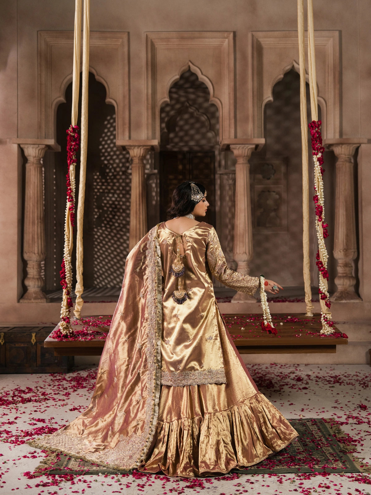 Pakistani wedding dress with a golden shirt, gharara, and embellished dupatta