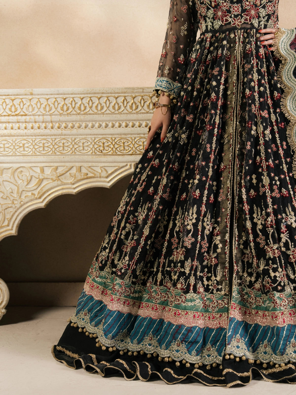 Elegant women’s black festive dress with detailed gold and floral embroidery