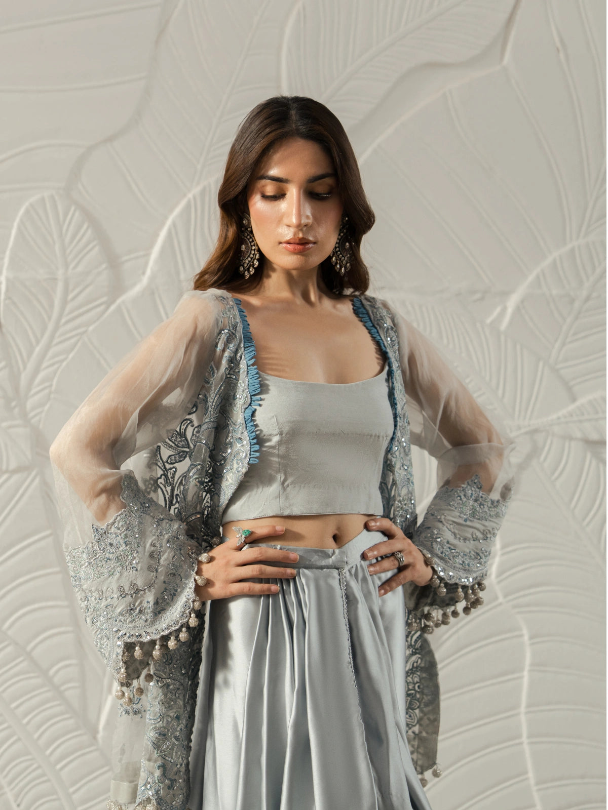 Luxury Pakistani women's fashion featuring an embroidered grey cape.