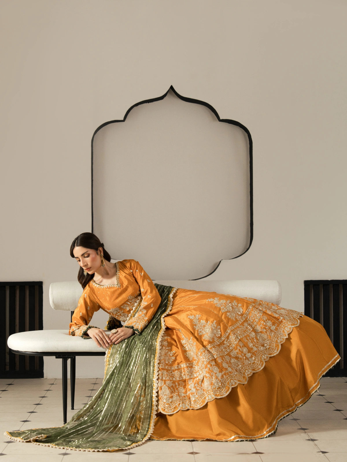 Luxury Pakistani women's maxi dress with floral embroidery and scalloped borders.