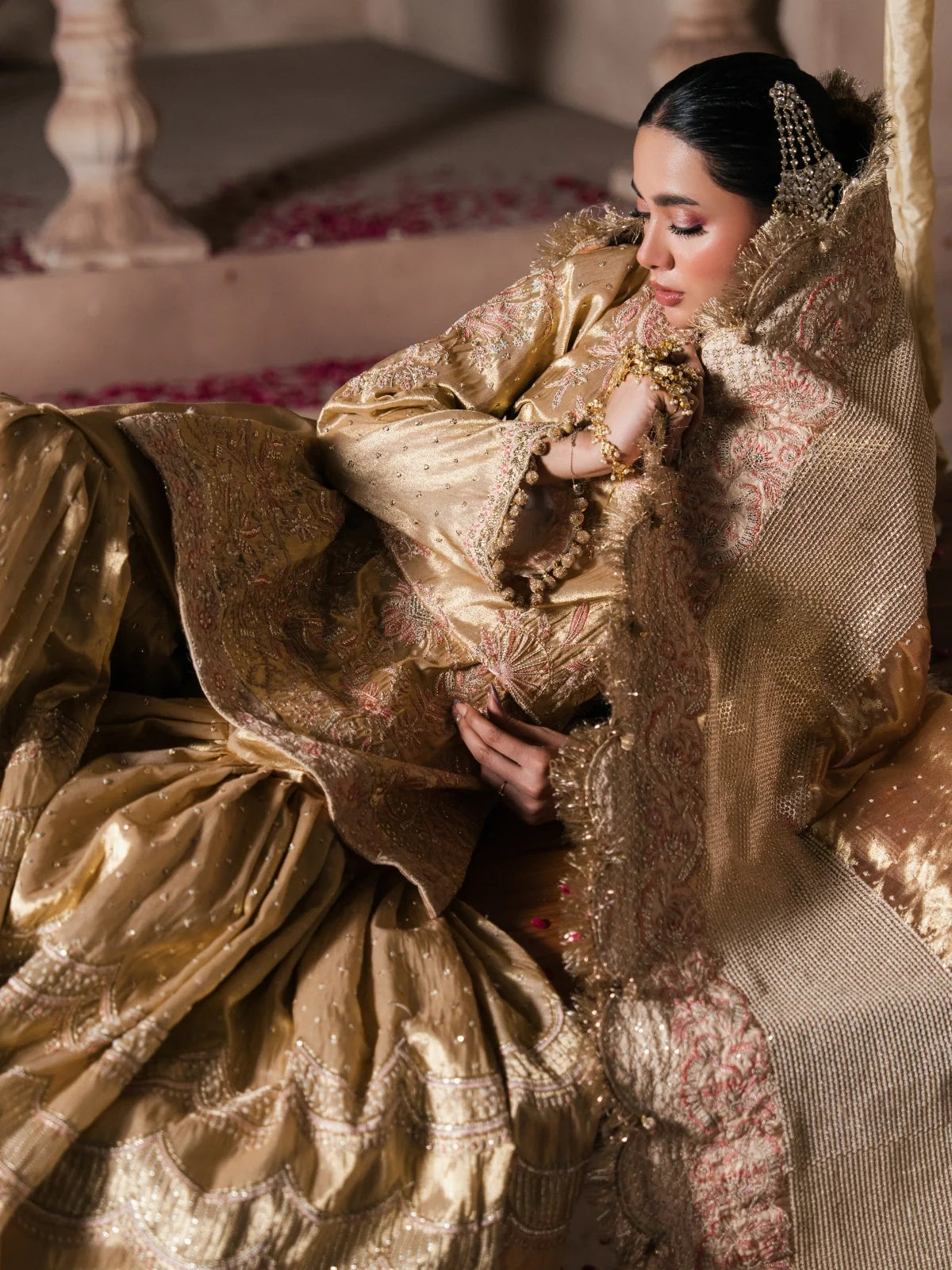 Luxury bridal sharara styled with a flowing pink and gold dupatta