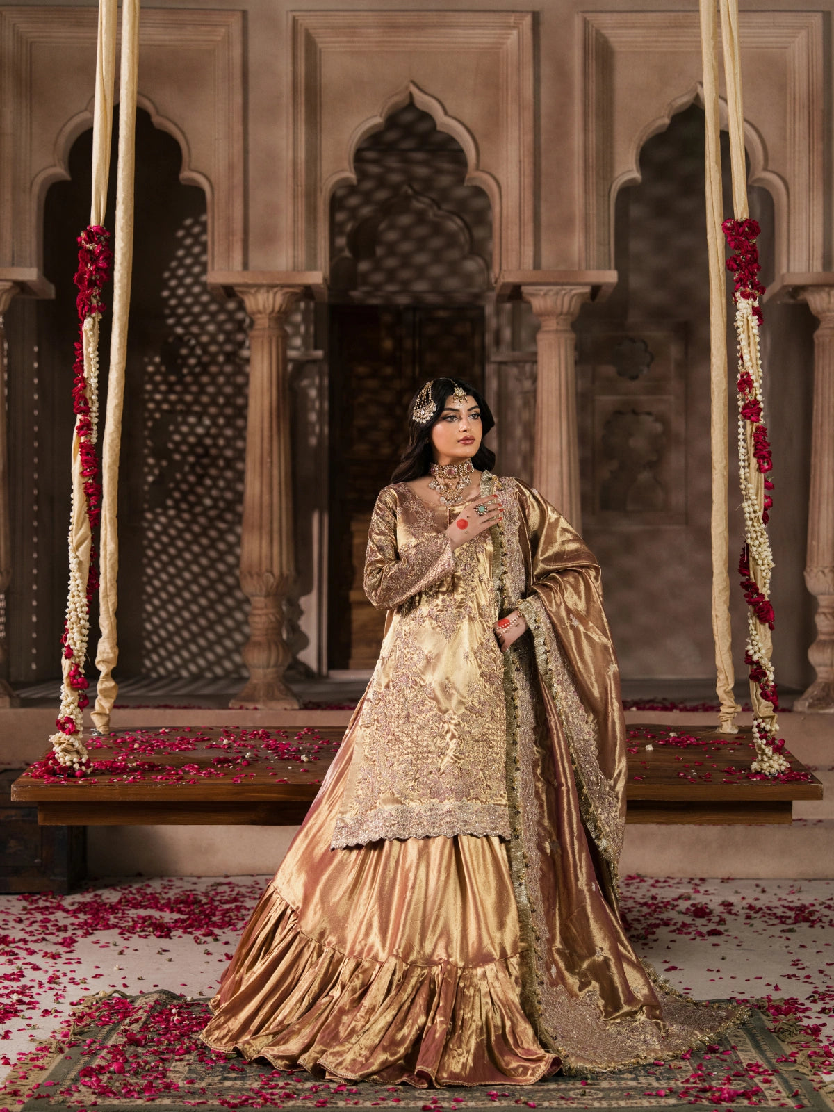 Champagne gold bridal outfit featuring intricate traditional embroidery