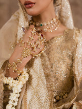 Close-up style view of an embroidered golden lehenga and dupatta