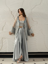 Elegant grey satin outfit with an embellished cape and matching trousers.