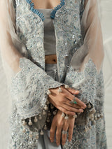 Full-length women's silver grey co-ord outfit styled with metallic heels.