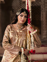 Elegant Pakistani wedding outfit in shimmering gold fabric