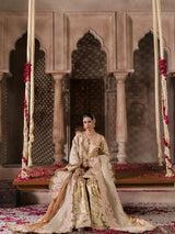 Pakistani bridal outfit featuring a golden sharara and blush pink embroidery