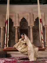 Traditional Pakistani formal wear with champagne gold fabric and detailed embroidery