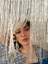 Close-up of silver embroidery on a royal blue women's formal kurta.