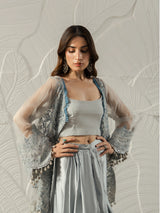Luxury Pakistani women's fashion featuring an embroidered grey cape.